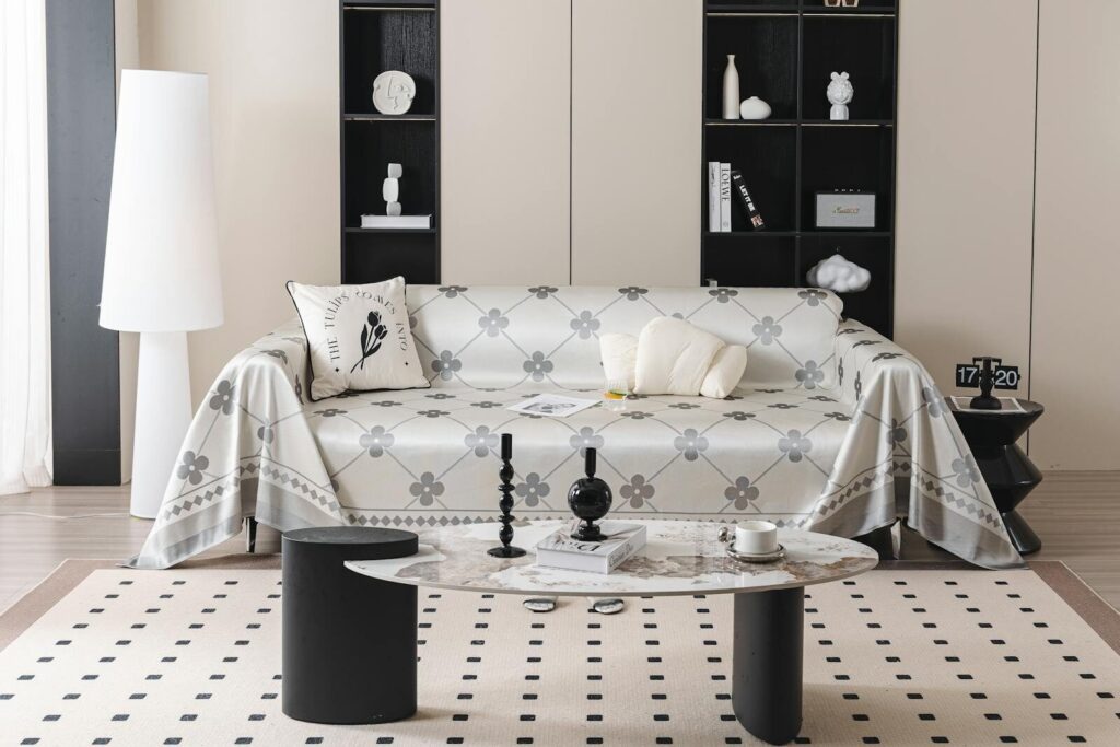 Elegant living room design featuring a stylish sofa with a geometric cover and modern furniture.